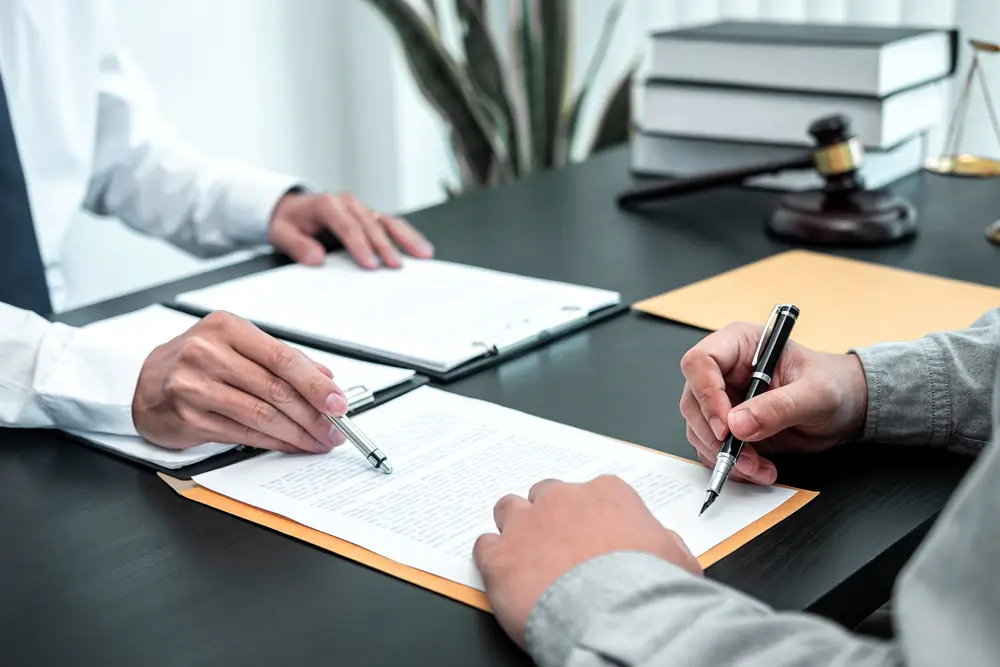 Photo of an Attorney with a Client discussing documentation