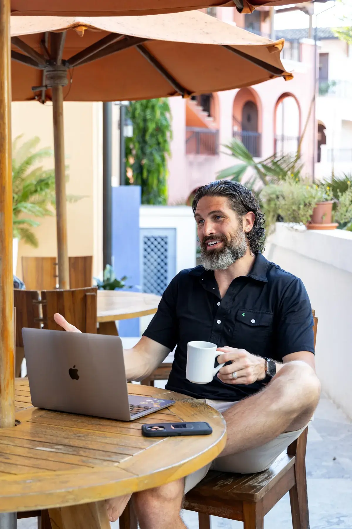 Chris Carsten working on a laptop at an outdoor café