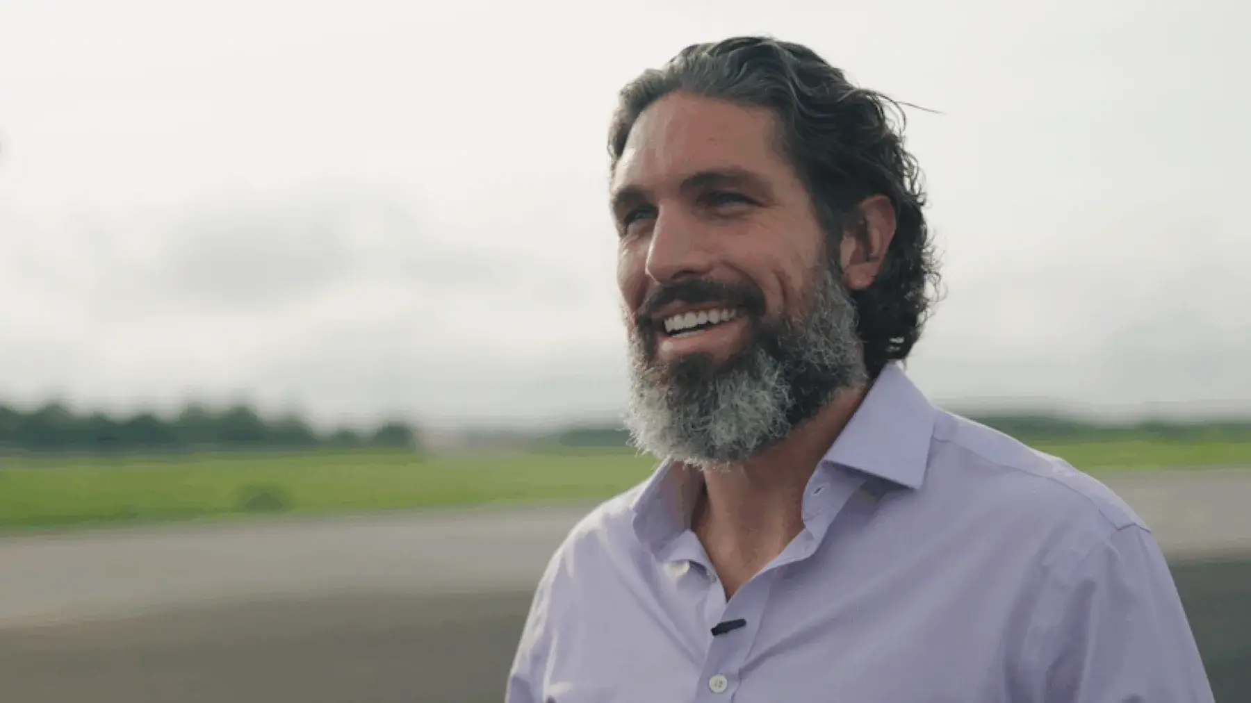 Chris Carsten smiling outdoors during an interview